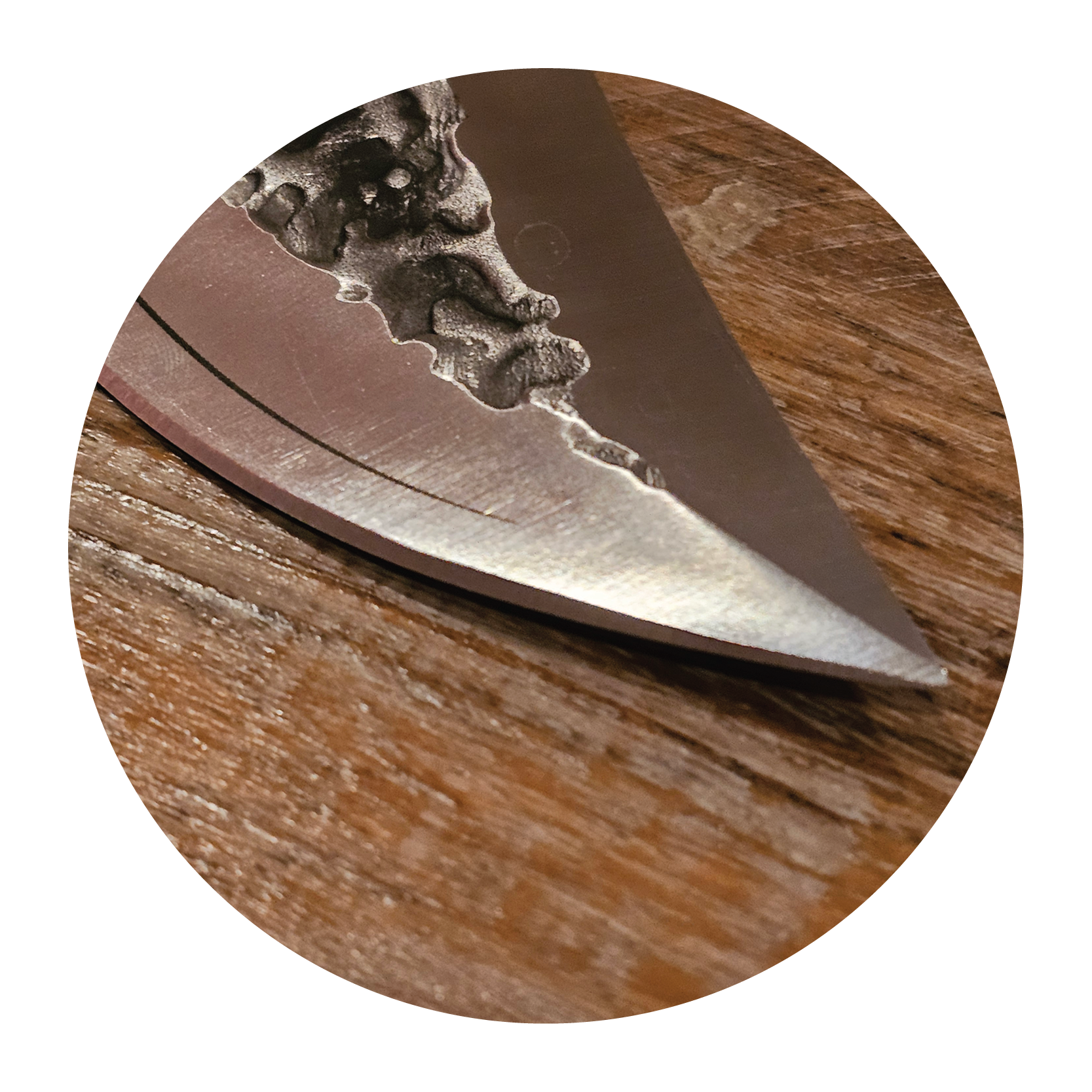 Close-up of a knife blade on a wooden surface