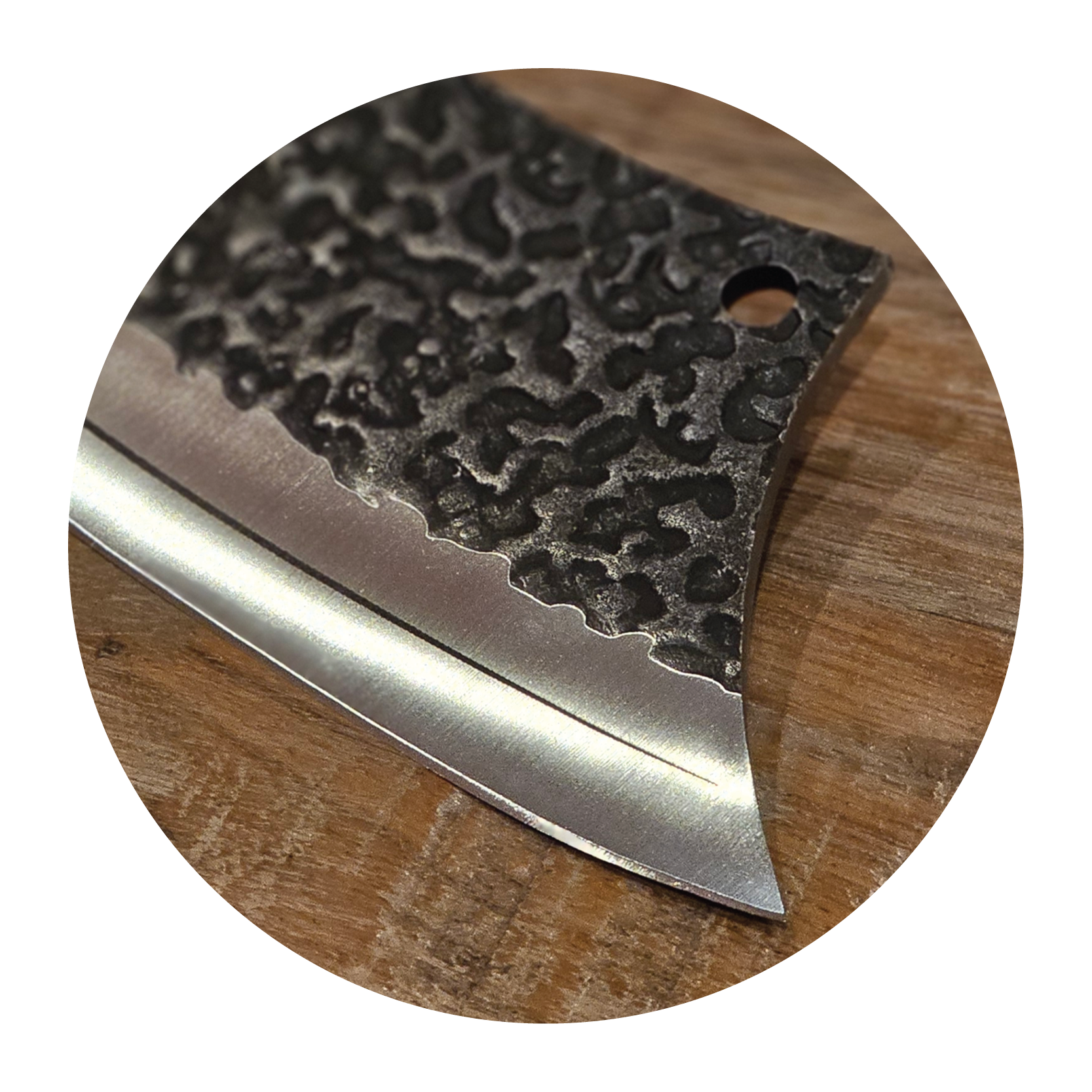 Close-up of a textured metal blade on a wooden surface