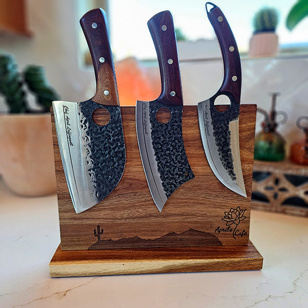 An engraved magnetic knife block made of acacia wood, featuring a double-sided magnet design. The block is displayed with three knives attached to it, showcasing the sleek design and wood grain.