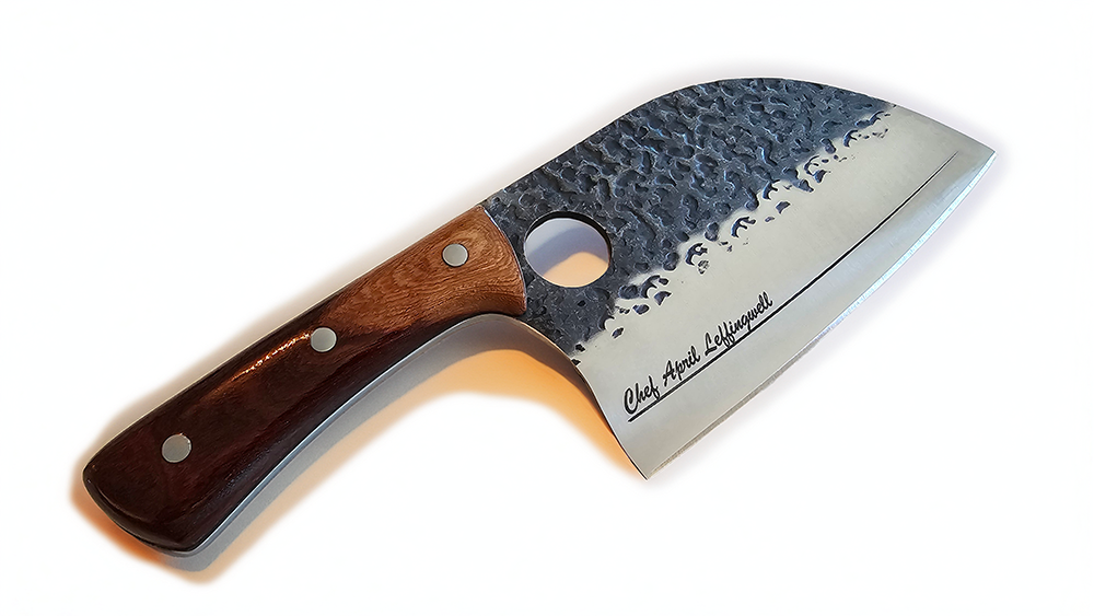 Engraved hammered steel butcher knife with wooden handle and textured metal blade on a white background